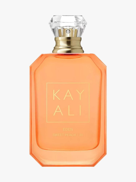 Peach colored bottle of KAYALI Eden Sweet Peach Eau de Parfum on light gray background
